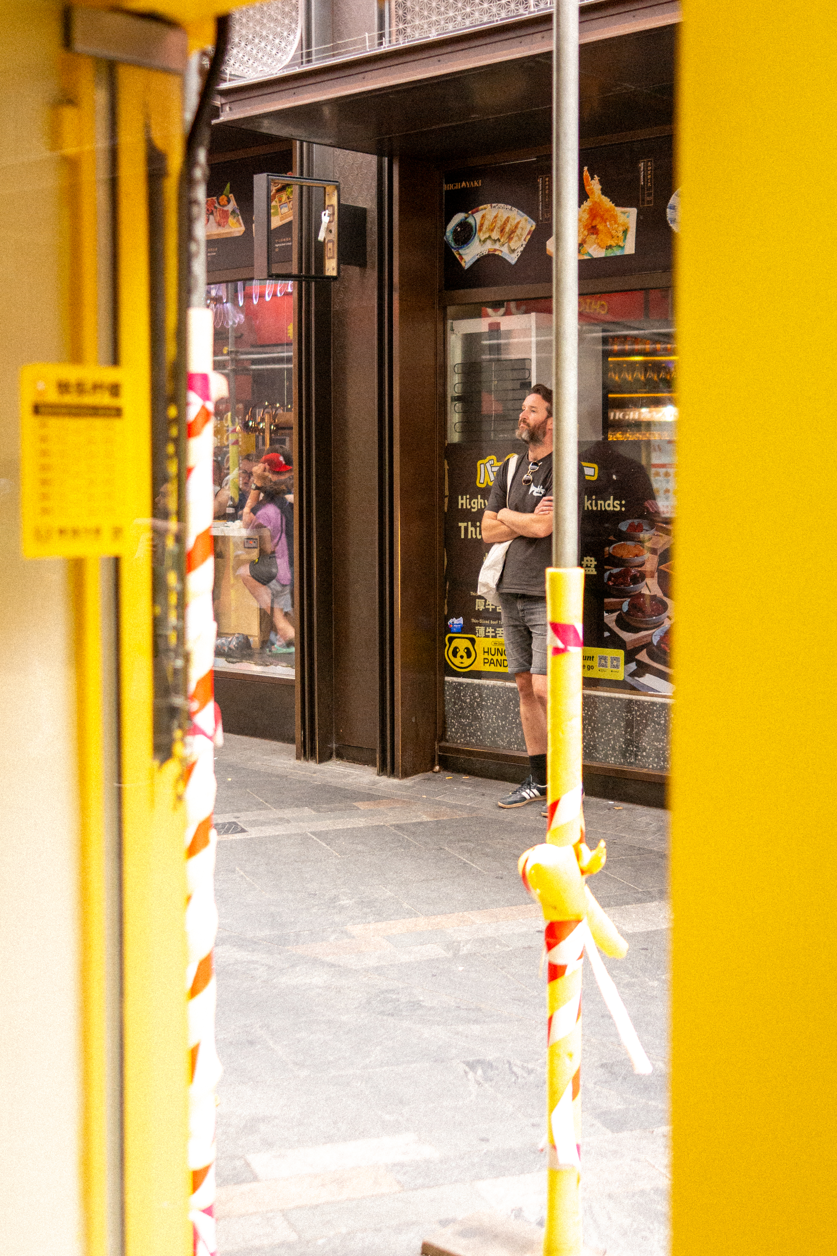 A man waiting in front of a store in chinatown